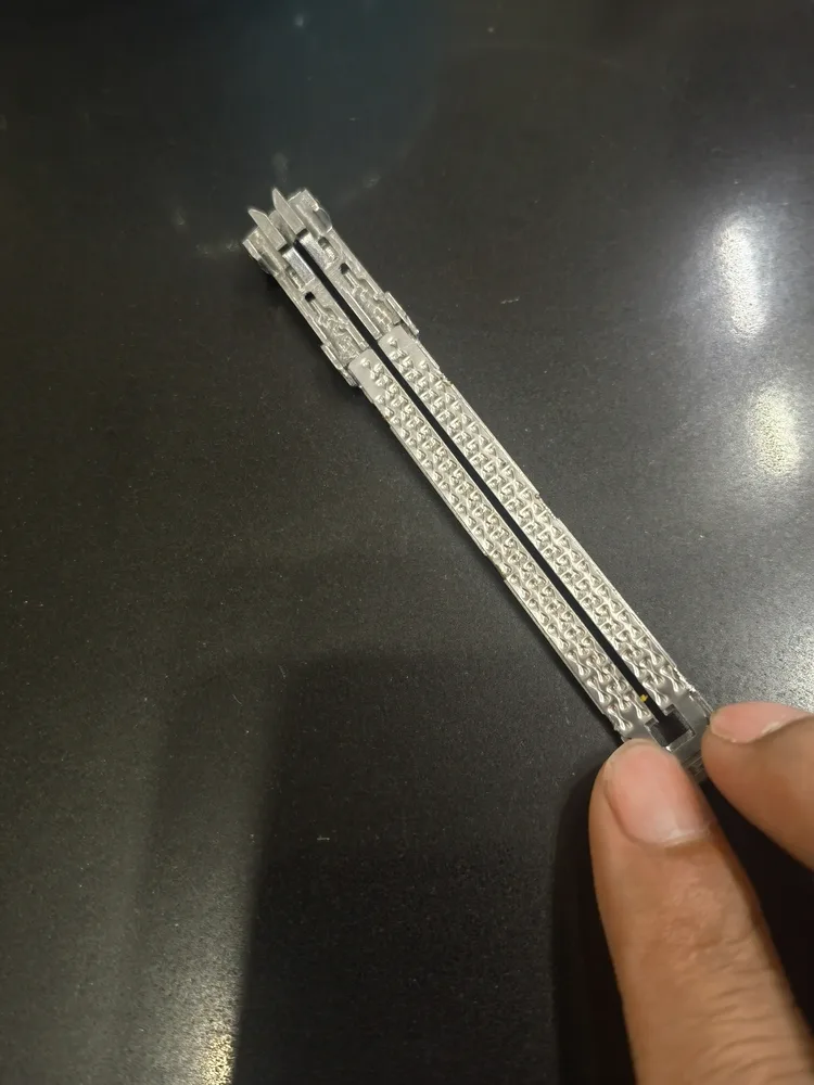 mim-precision-scale A MIM-produced component held in hand — showing the fine detail and surface quality achievable at small scale